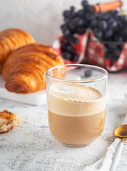 breakfast with cappuccino, croissants and berries, a glass of coffee, close-up