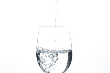 A glass of water on a white background. Close-up