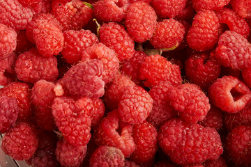 ripe raspberries with green leaf isolated on white background macro