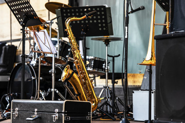 Fototapeta na wymiar brass musical instrument saxophone on the open stage.