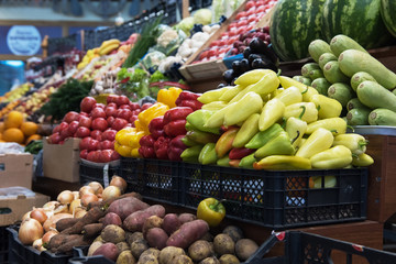 Vegetable farmer market counter: colorful various fresh organic healthy vegetables at grocery store. Healthy natural food concept