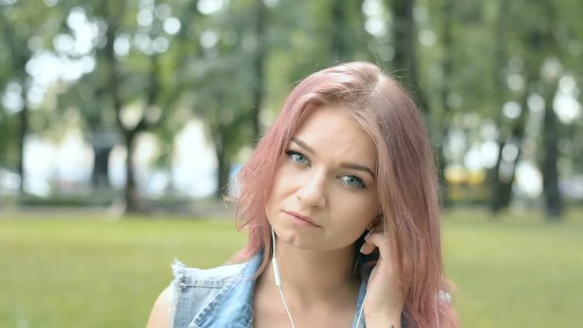 portrait of a young hipster girl with red hair in a city park hd stock footage