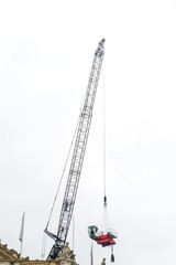 Fototapeta premium Crane looking tall in a construction site