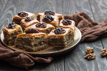 Baklava. Ramadan Dessert. Traditional Arabic dessert with walnuts and honey on a wooden table. 