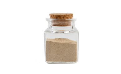 cardamon powder in glass  jar on isolated on white background. front view. spices and food ingredients.