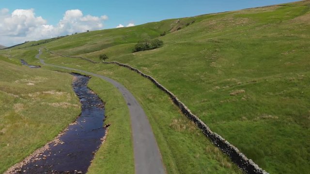 Descending shot into the Barbon Beck Valley, Carnforth, Lancashire. This stunning countryside features a stream running alongside a small country lane.