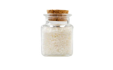 coconut shreds in glass  jar on isolated on white background. front view. spices and food ingredients.