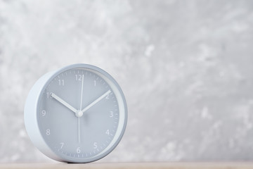 Classic alarm clock on a gray background with copy space