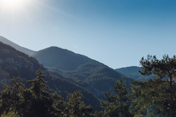 Beautiful landscape in the mountains at sunset. Lovely view of the Taurus Mountains at sunset. Soft sunlight falls on the mountain tops. Kemer, Turkey. Postcard view