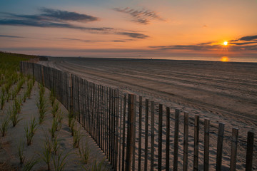Beautiful sunrise over Lavallette Beach, New Jersey featuring sand on the foreground and sunny sky on the background