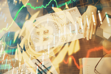 Cryptocurrency hologram over woman's hands writing background. Concept of blockchain. Double...