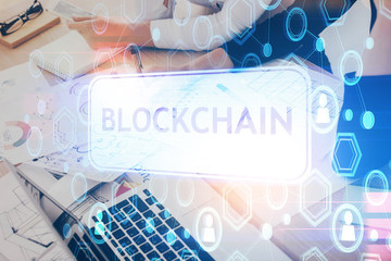 Cryptocurrency hologram over woman's hands writing background. Concept of blockchain. Multi exposure