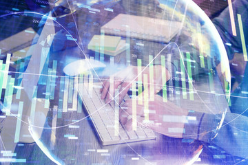 Fototapeta premium Double exposure of businessman working on laptop on background. International business hologram in front. Concept of success.