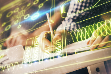 Man's hands working with notes background. Modern computer record diagram with virtual mnitor.