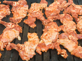Meatballs and chicken cooked on a barbecue