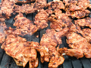 Meatballs and chicken cooked on a barbecue