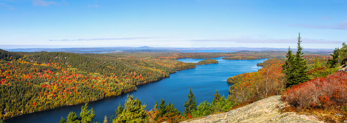 Panoramic aerial view of the blue water and fall foliage surrounding Long Pond in Acadia National Park - Powered by Adobe