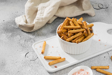 Breadsticks with sesame seeds. Pastry. Light background