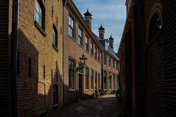 Leiden, Holland, Netherlands, May 22, 2019. Narrow Street view, traditional houses and parcked bicycles 