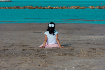 Lonely child thinking beside the beach seaside