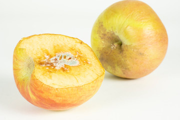 Naklejka na ściany i meble rotten apple on white in top view. Apple biting rotten bruise.