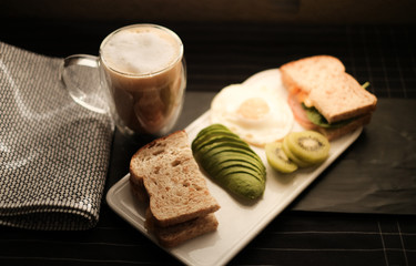 Rustic breakfast . Healthy diet with coffee ,bread , avocado and kiwi.