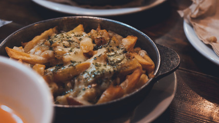 Tapa with potatoes on wooden table