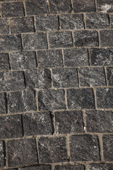 Abstract background of gray cobblestone pavement,close-up, top view.