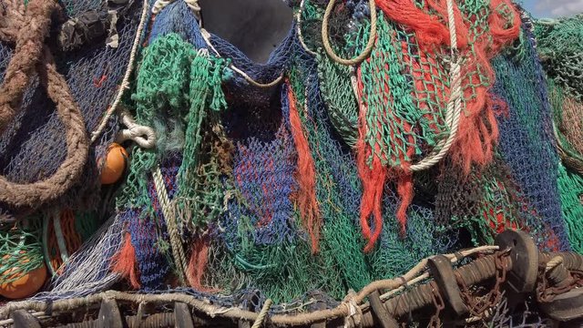 Tilt up over the colourful fishermans nets in Dorset England