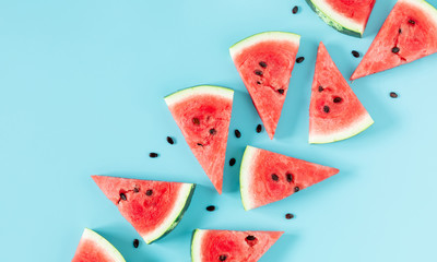 Sliced watermelon on light blue background. Watermelon slice. Summer concept. Flat lay, top view, copy space