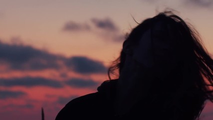 Girl shakes long hair outdoor enjoying fresh summer evening slow motion. Close up side portrait of young woman posing with hair flying in wind sunset background. Freedom female beauty haircare product