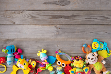 Set of toys for newborn on wooden background. top view