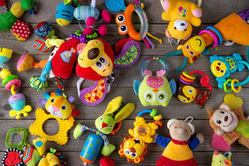 Fototapeta na wymiar Set of toys for newborn on wooden background. top view