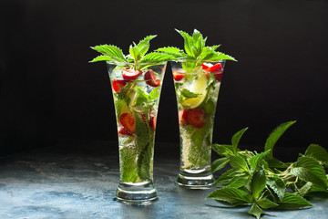 Citrus fruit cocktail with   mint, lime and strawberry  in glass