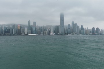 Fototapeta premium 08 03 2019 China, Hong Kong, Victoria Harbour - skyline in a cludy day