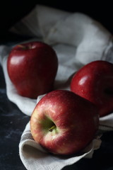 Red apples on a black background, still life apples
