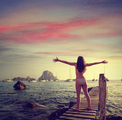 Fototapeta premium Ibiza cala d Hort girl pier sunset Es Vedra