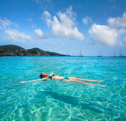 Ibiza bikini girl swimming clear water beach