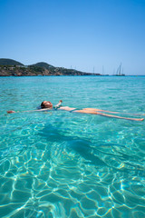 Ibiza bikini girl swimming clear water beach