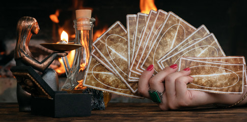 Tarot cards on fortune teller table on a burning fire background. Futune reading concept....