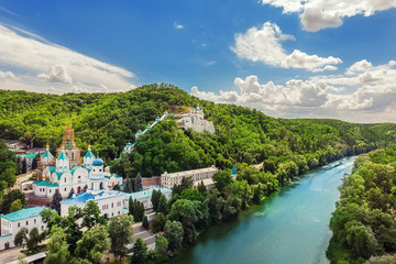 Fototapeta na wymiar Svaytogorsk lavra ancient monastery hills panoramic view with green forest and Donets river at Donbass, Ukraine on bright sunny day. Ukraine travel destination place. Ukrainian tourism