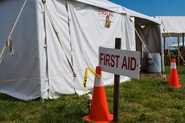 First aid sign in front of tent