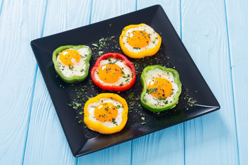 Yellow , red and green pepper with fried eggs