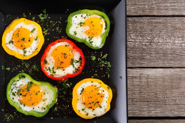 Yellow , red and green pepper with fried eggs