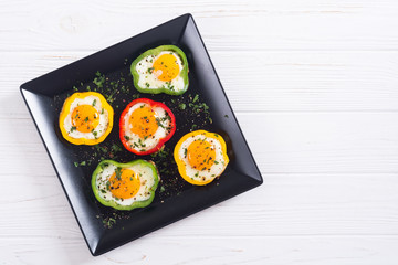 Yellow , red and green pepper with fried eggs