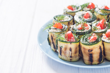 Zucchini rolls with cream cheese , tomatoes and dill