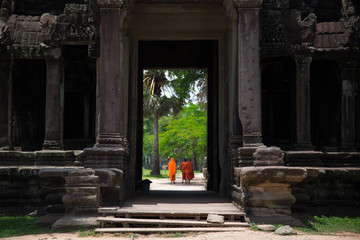 Temple doorway with monks visible on the other side.