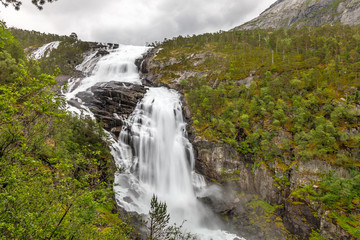 Fototapeta na wymiar Nyastolfossen waterfall powerful streams in Husedalen valley, Kinsarvik, municipality Ullensvang, Hordaland county, Norway