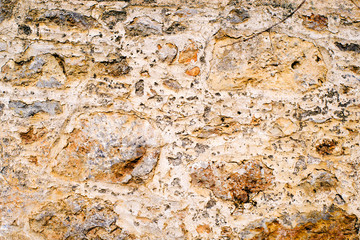 Ancient wall, old laying of walls from a stone. Textural grunge background