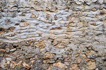 Ancient wall, old laying of walls from a stone. Textural grunge background